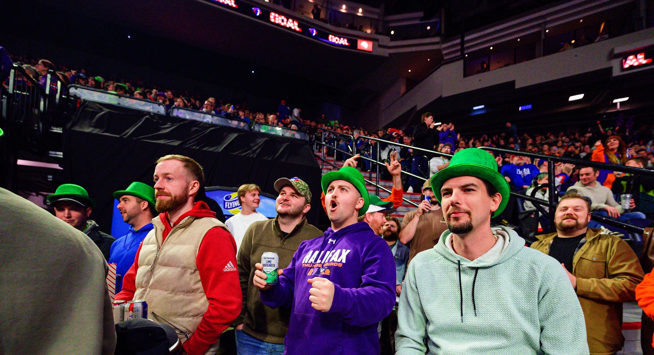 Thunderbirds fans in green hats cheering at Scotiabank Centre